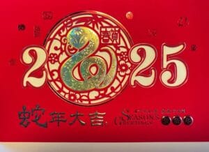 A Chinese New Year card is shown for 2025, the year of the Wood Snake